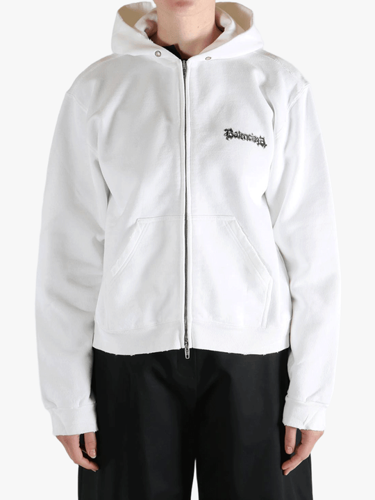 White hoodie worn by a person, showing the shirt's fit