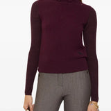 Red knitwear worn by a person, showing the knitwear's fit