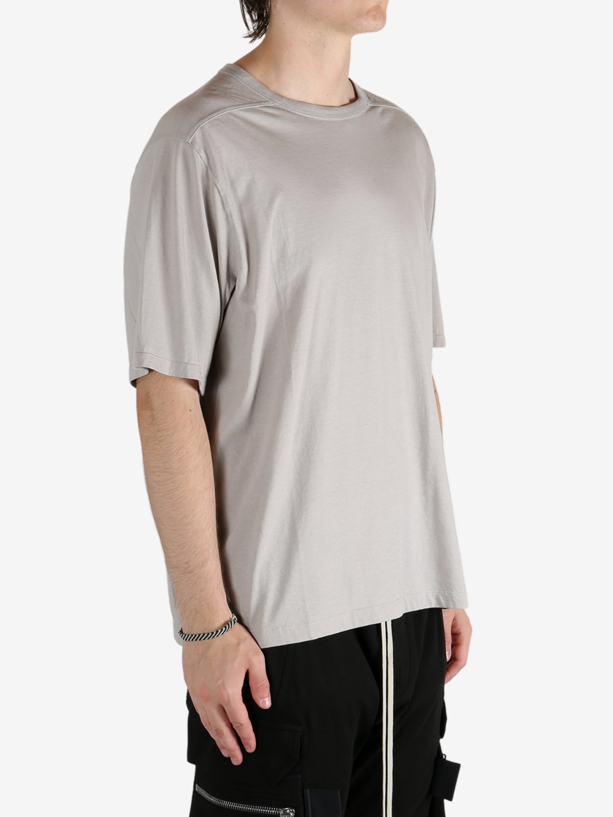 Grey shirts worn by a person, showing the shirt's fit