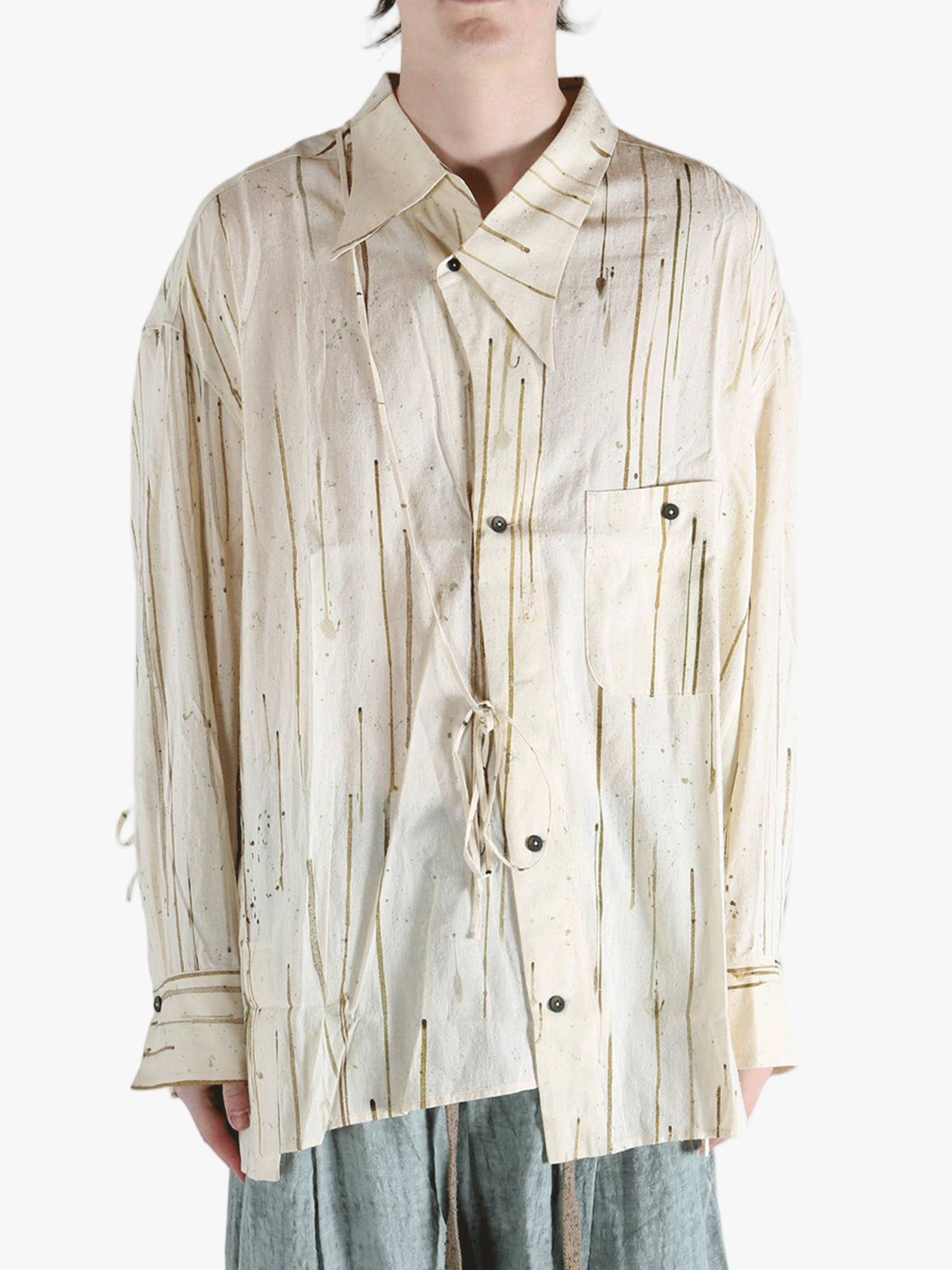 Tan shirt worn by a person, showing the shirt's fit