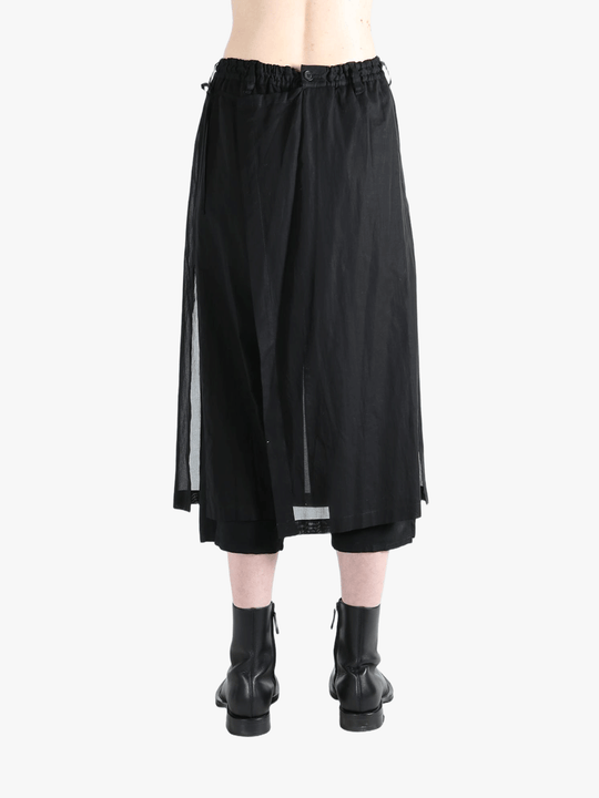 Black pants worn by a person, showing the pants fit