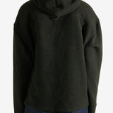 Green hoodie worn by a person, showing the hoodie's fit