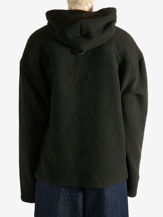 Green hoodie worn by a person, showing the hoodie's fit