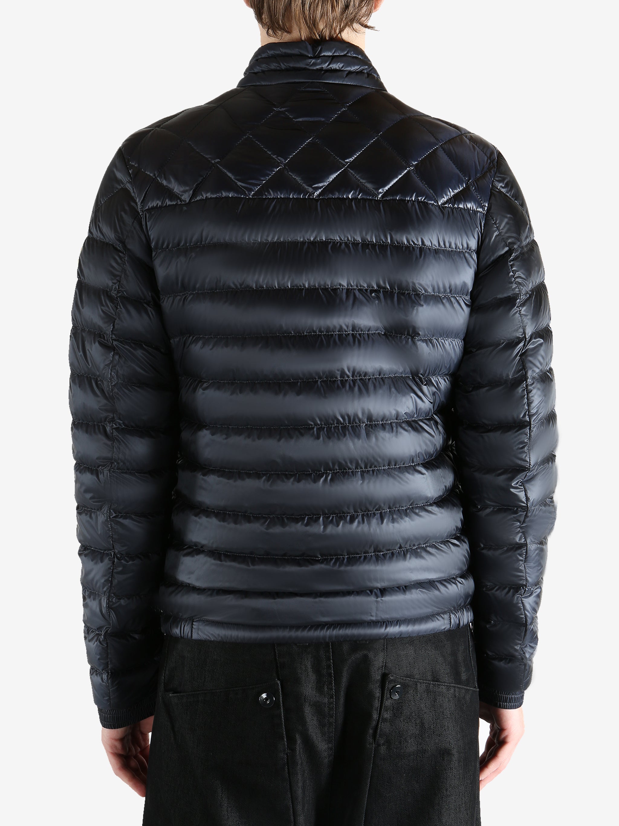 Black jacket worn by a person, showing the jacket fit