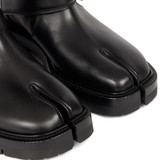 Close up of black boots showing texture of the leather fabric