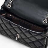 close up of black bags, showing texture of the leather fabric