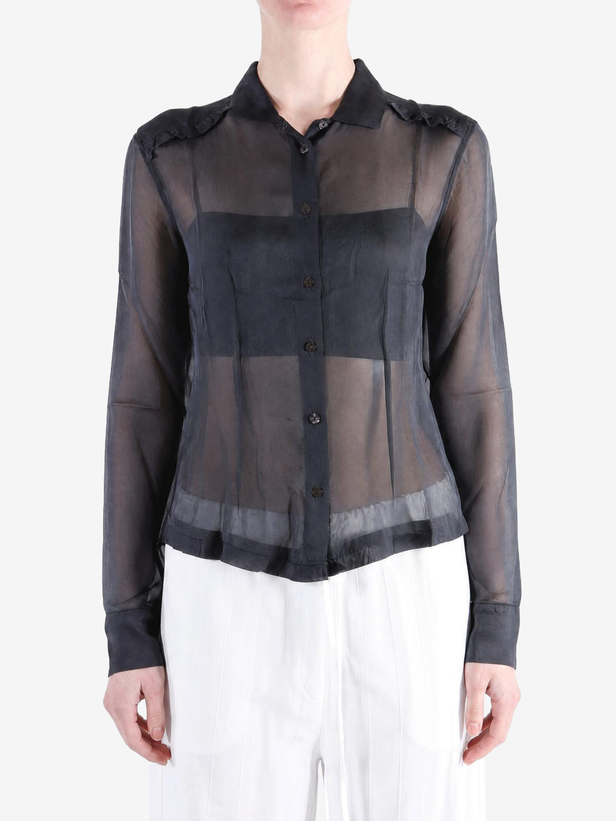 Black shirt worn by a person, showing the shirt fit
