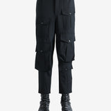 Black pants worn by a person, showing the pants fit