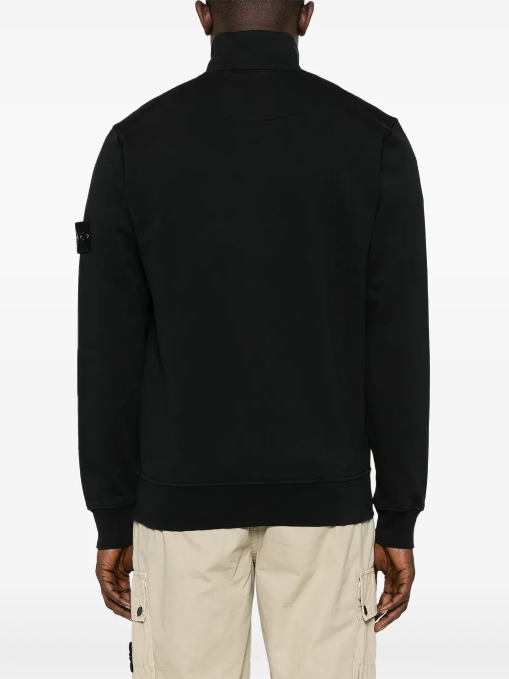 Black jacket worn by a person, showing the jacket fit