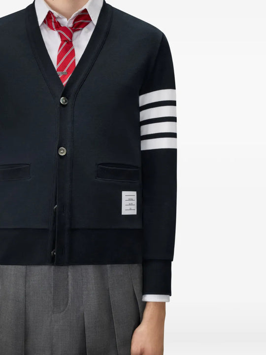 Navy knitwear worn by a person, showing the knitwear fit