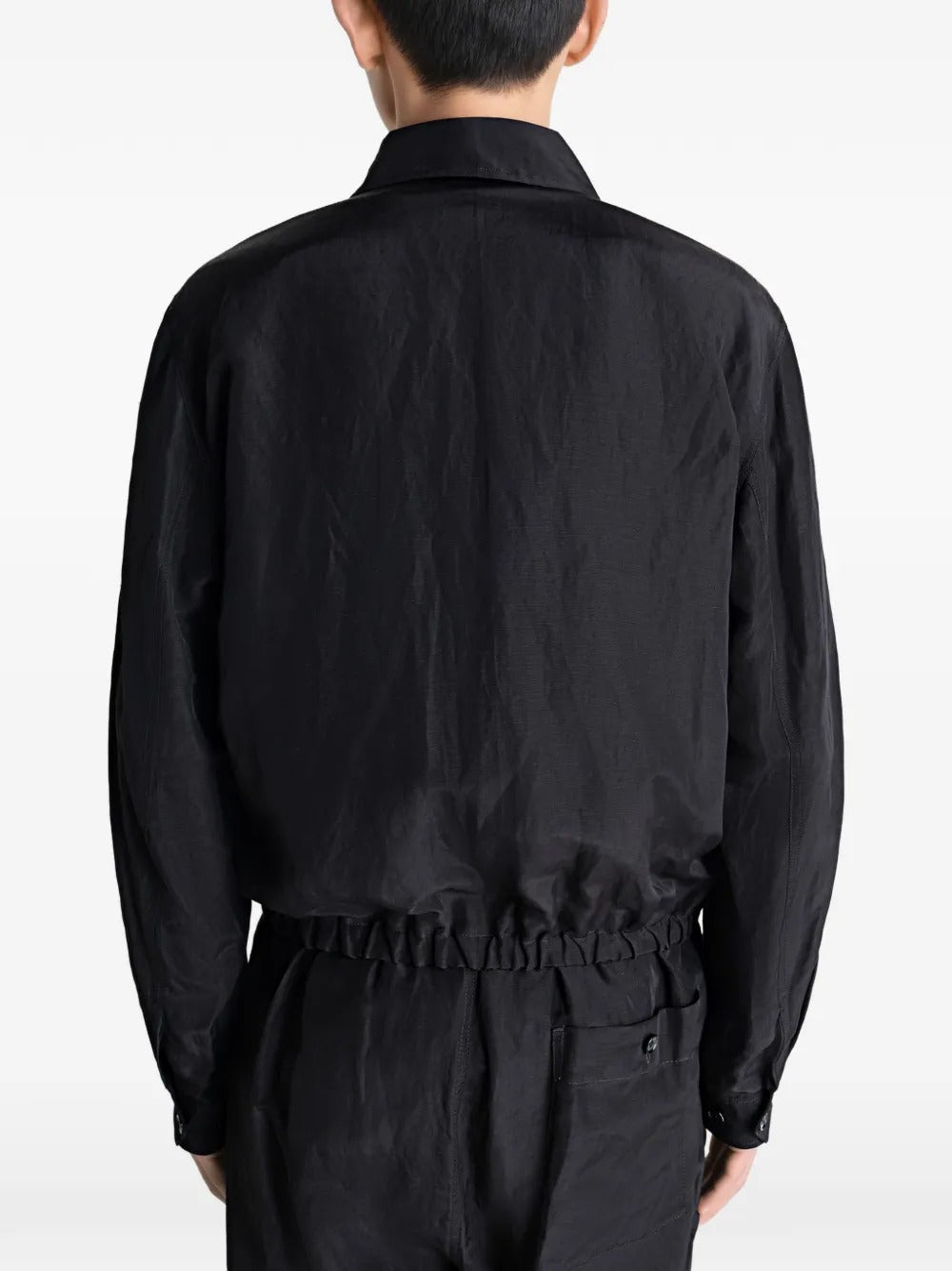 Black jacket worn by a person, showing the jacket's fit