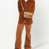 Tan bag carried by a person, showing the bag's fit