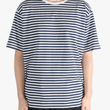 Black tee worn by a person, showing the tees fit