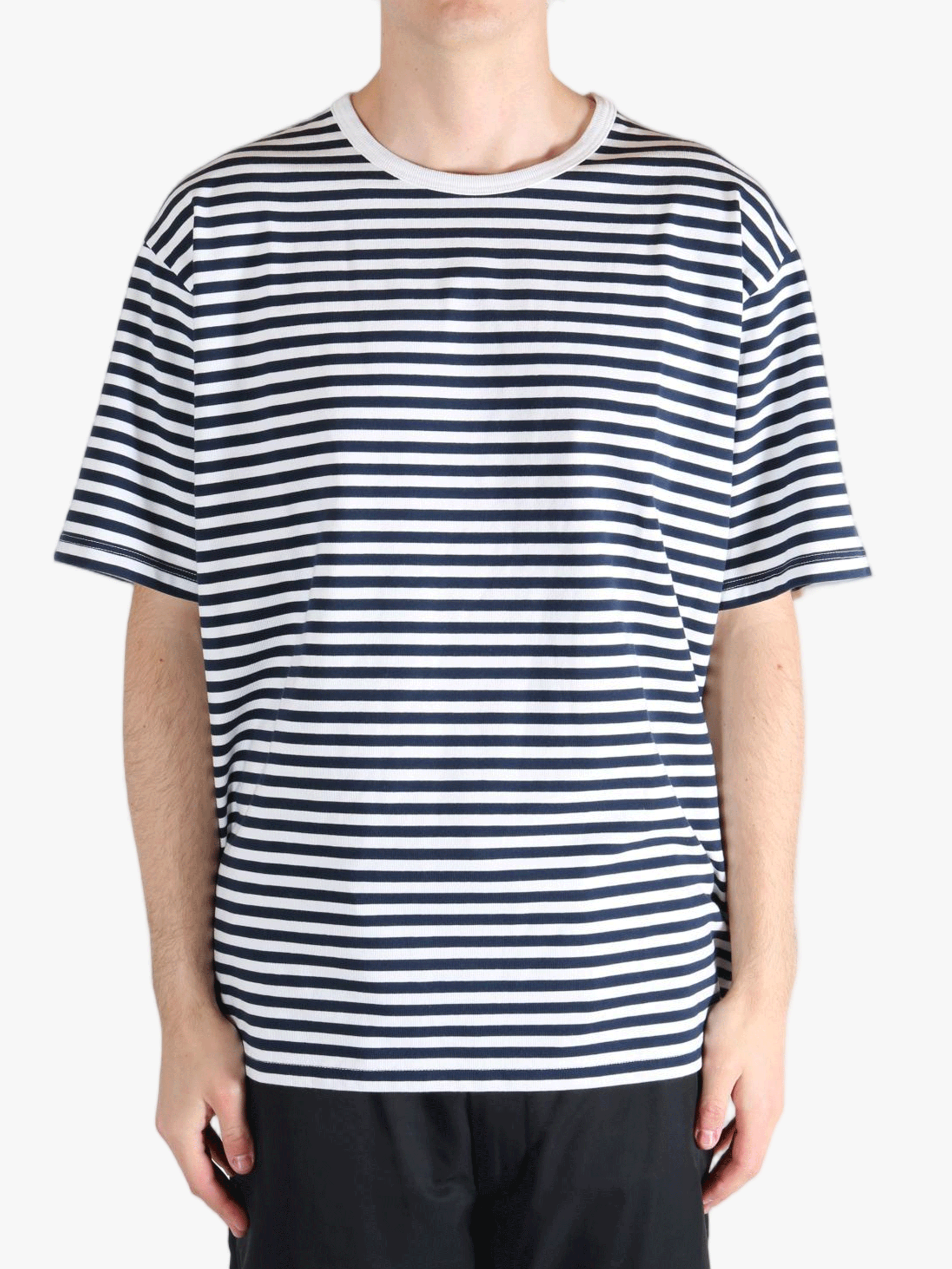 Black tee worn by a person, showing the tees fit