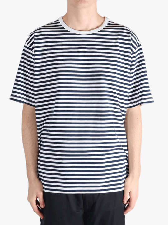 Black tee worn by a person, showing the tees fit