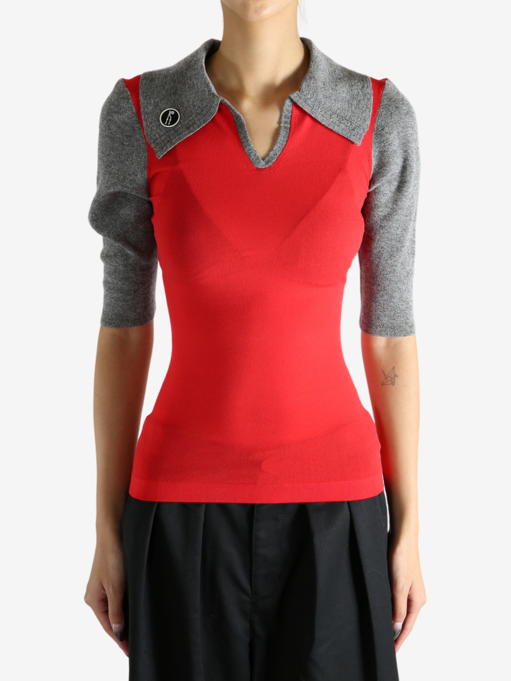 Red knitwear worn by a person, showing the knitwear's fit