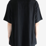 Black t-shirts worn by a person, showing the t-shirts' fit