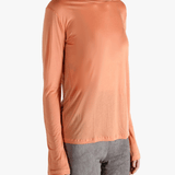 Orange shirts worn by a person, showing the  shirt's  fit