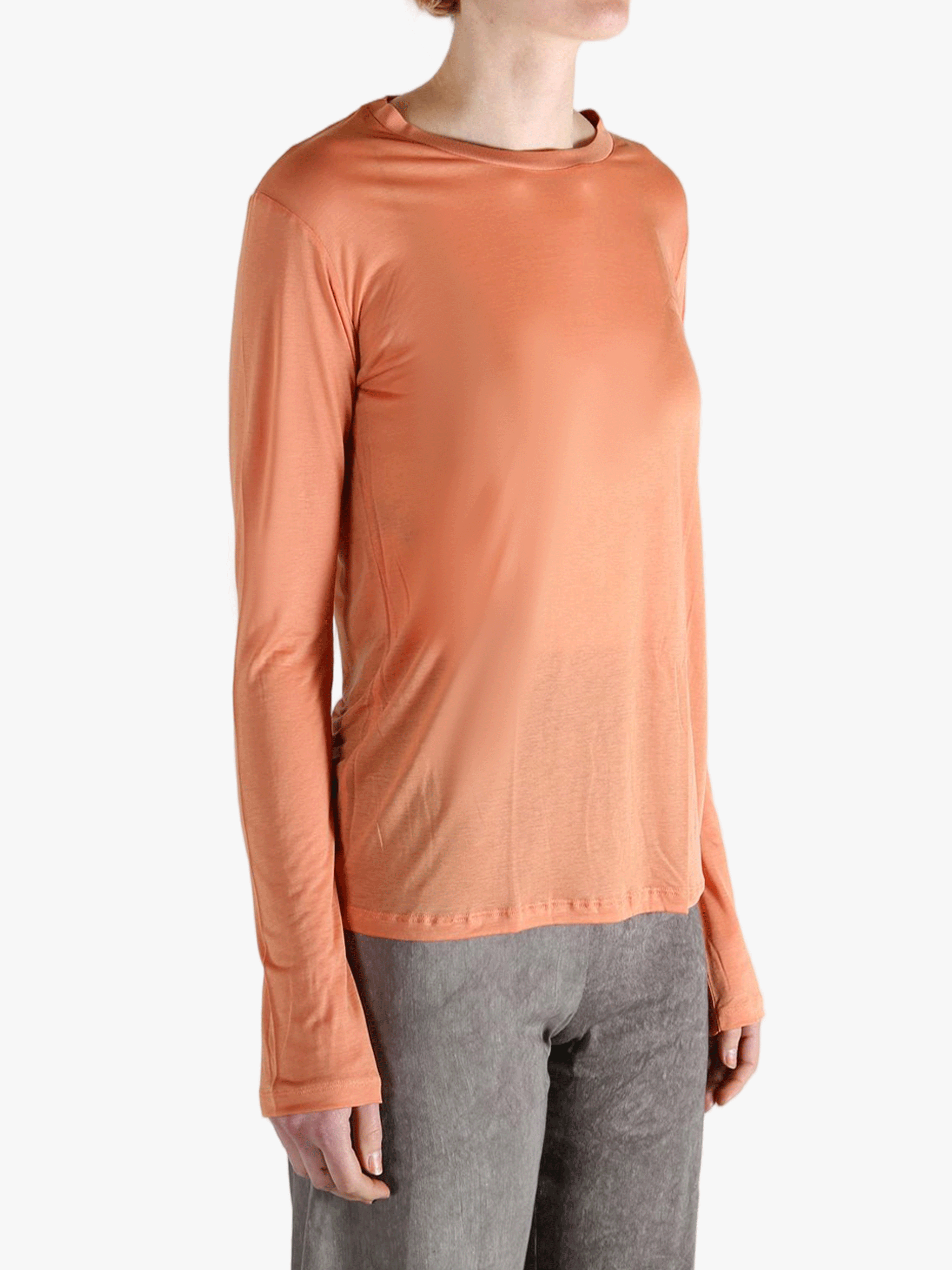 Orange shirts worn by a person, showing the  shirt's  fit