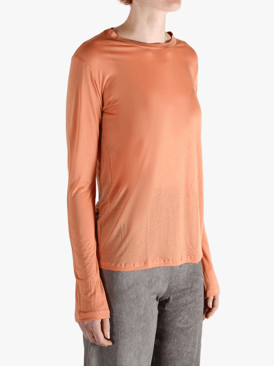 Orange shirts worn by a person, showing the  shirt's  fit