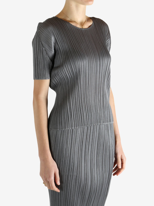 Grey shirts worn by a person, showing the shirts fit