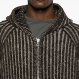 Close up of brown jackets, showing texture of the wool fabric