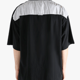 Black t-shirt worn by a person, showing the shirt's fit