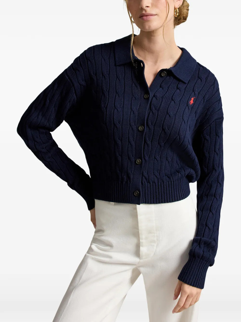 Navy knitwear worn by a person, showing the knitwear fit