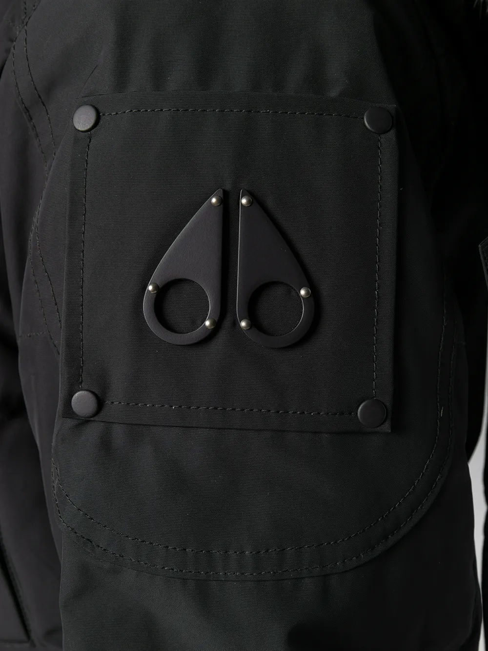 Close up of black jackets, showing texture of the nylon and polyester and feather down fabric