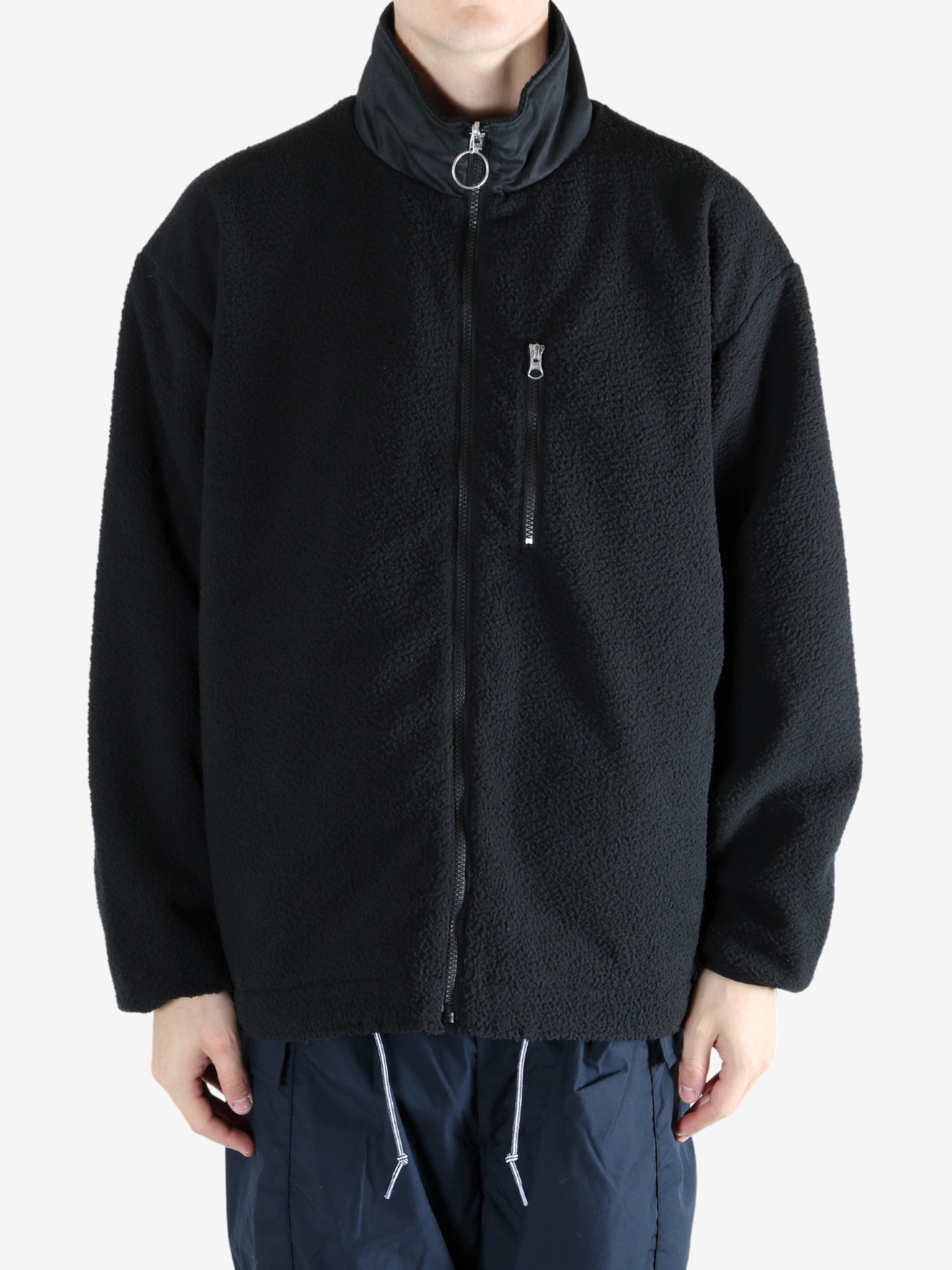 Black jacket worn by a person, showing the jacket's fit