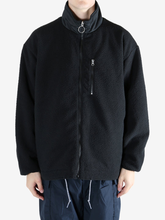 Black jacket worn by a person, showing the jacket's fit