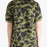 Green shirt worn by a person, showing the shit fit