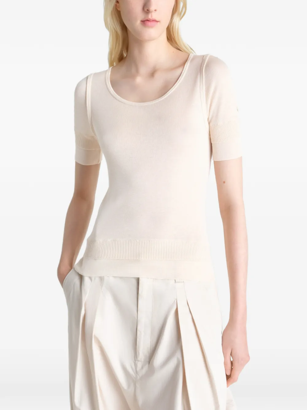 white tops  worn by a person, showing the tops fit