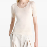 white tops  worn by a person, showing the tops fit
