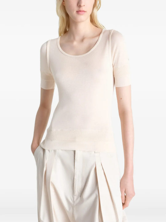 white tops  worn by a person, showing the tops fit