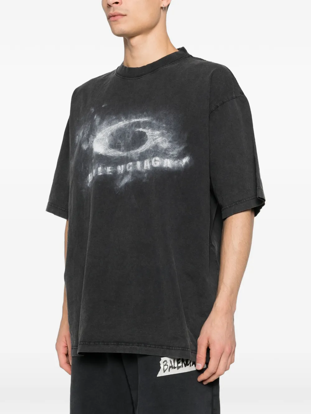 black t-shirt worn by a person, showing the t-shirt fit