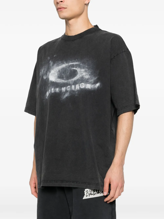 black t-shirt worn by a person, showing the t-shirt fit