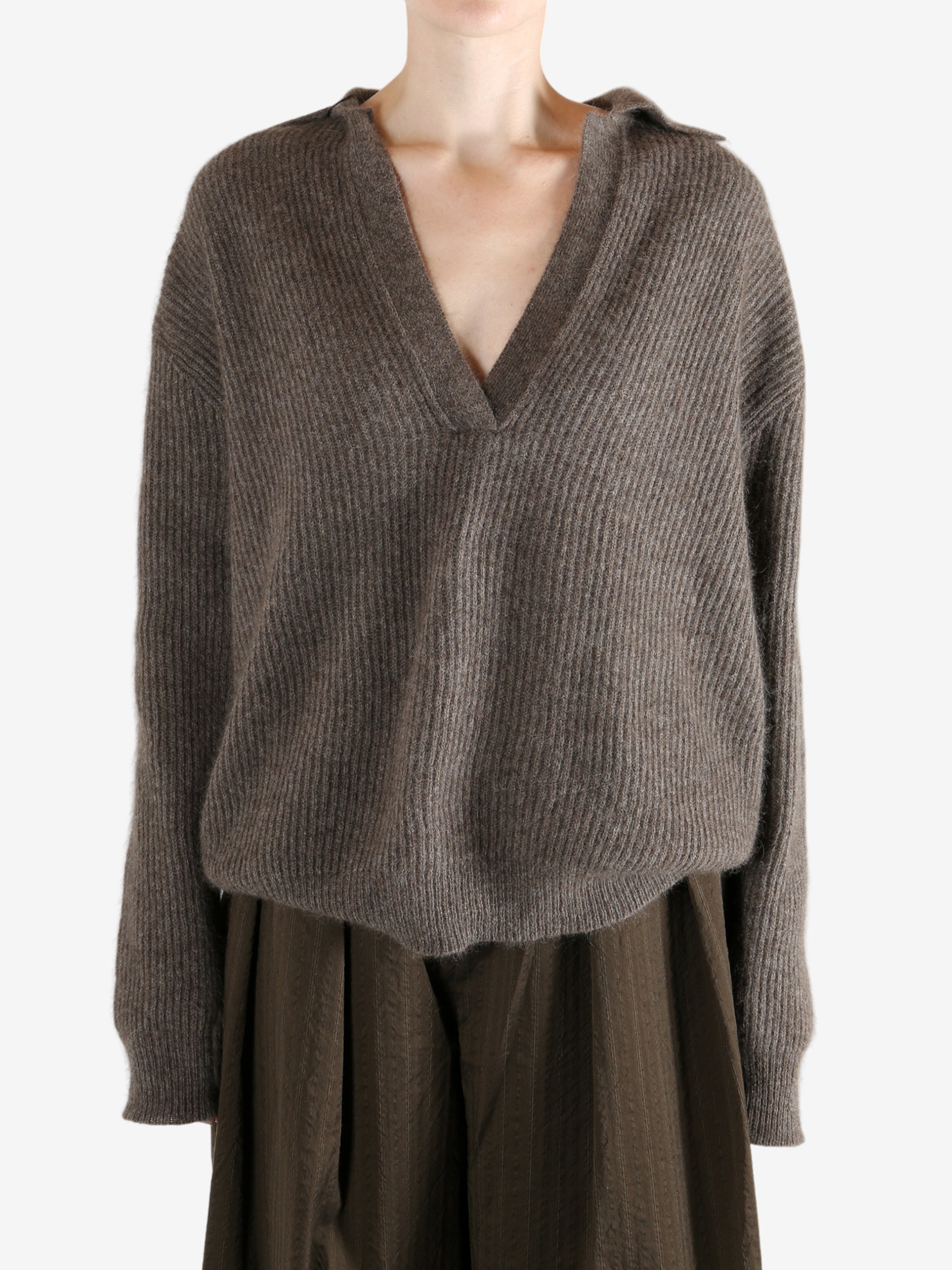 Brown sweater worn by a person, showing the sweater's fit