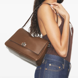 Brown bags worn by a person, showing the bags's fit