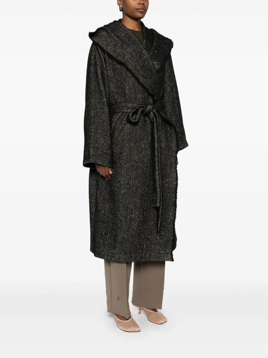 Black coat  worn by a person, showing the coat's fit