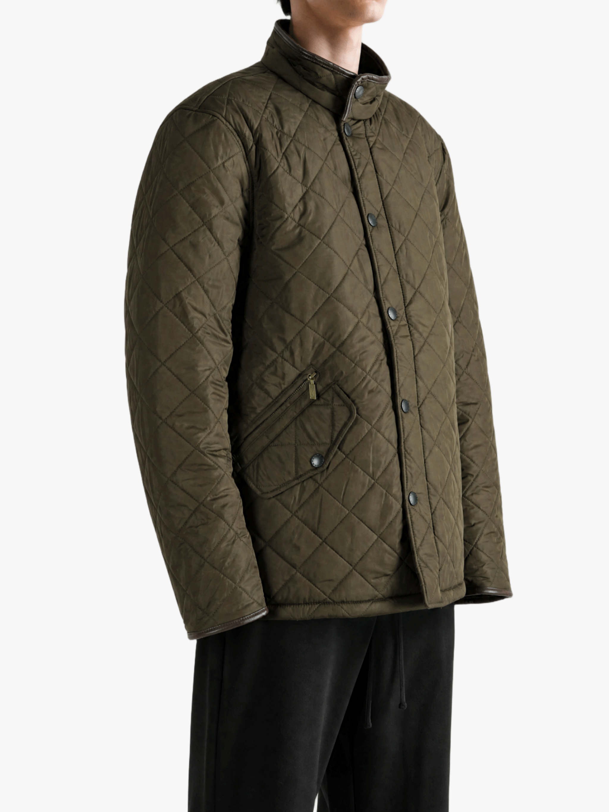 Green jacket worn by a person, showing the jacket fit