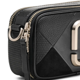 Close up of black bags, showing texture of the leather fabric