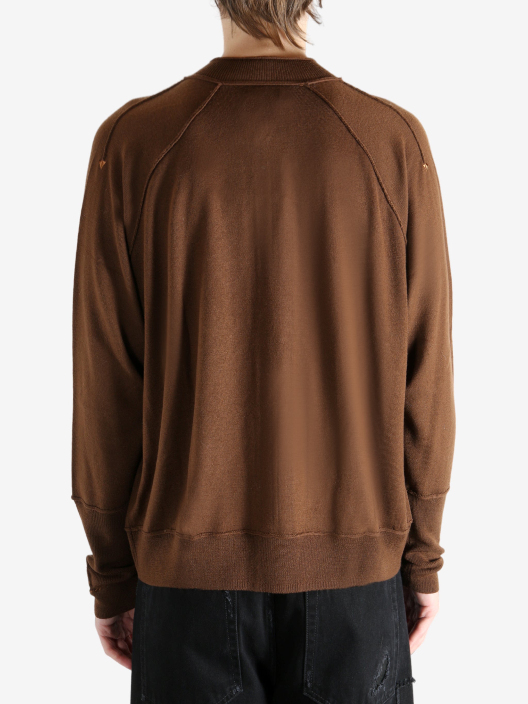 Brown cardigan worn by a person, showing the cardigan's fit