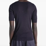 Black top worn by a person, showing the top's fit