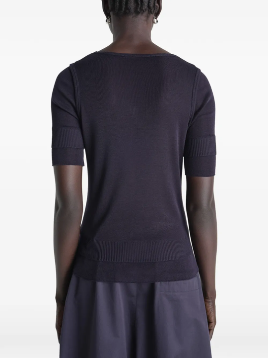 Black top worn by a person, showing the top's fit