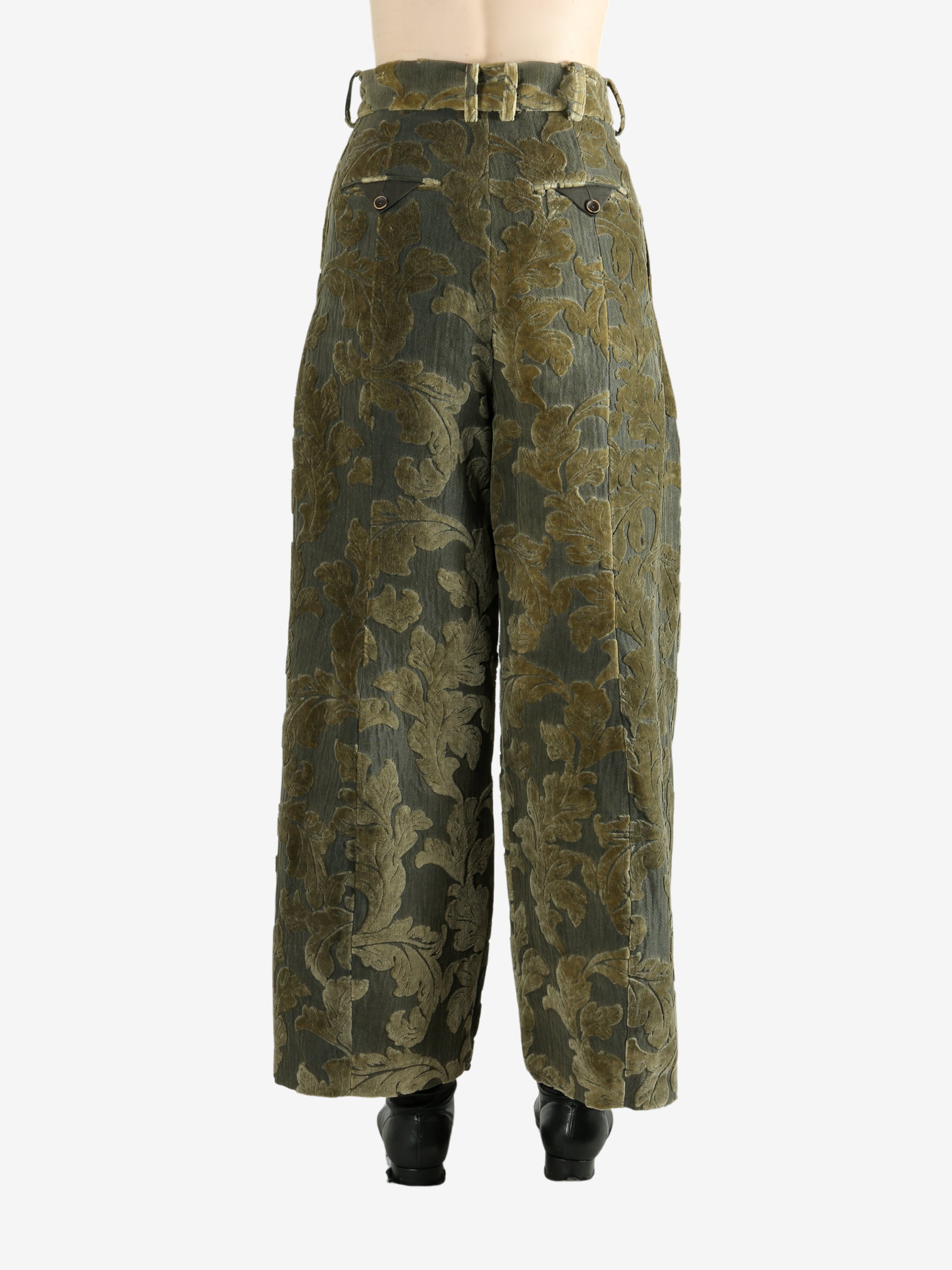 Green pants worn by a person, showing the pants' fit