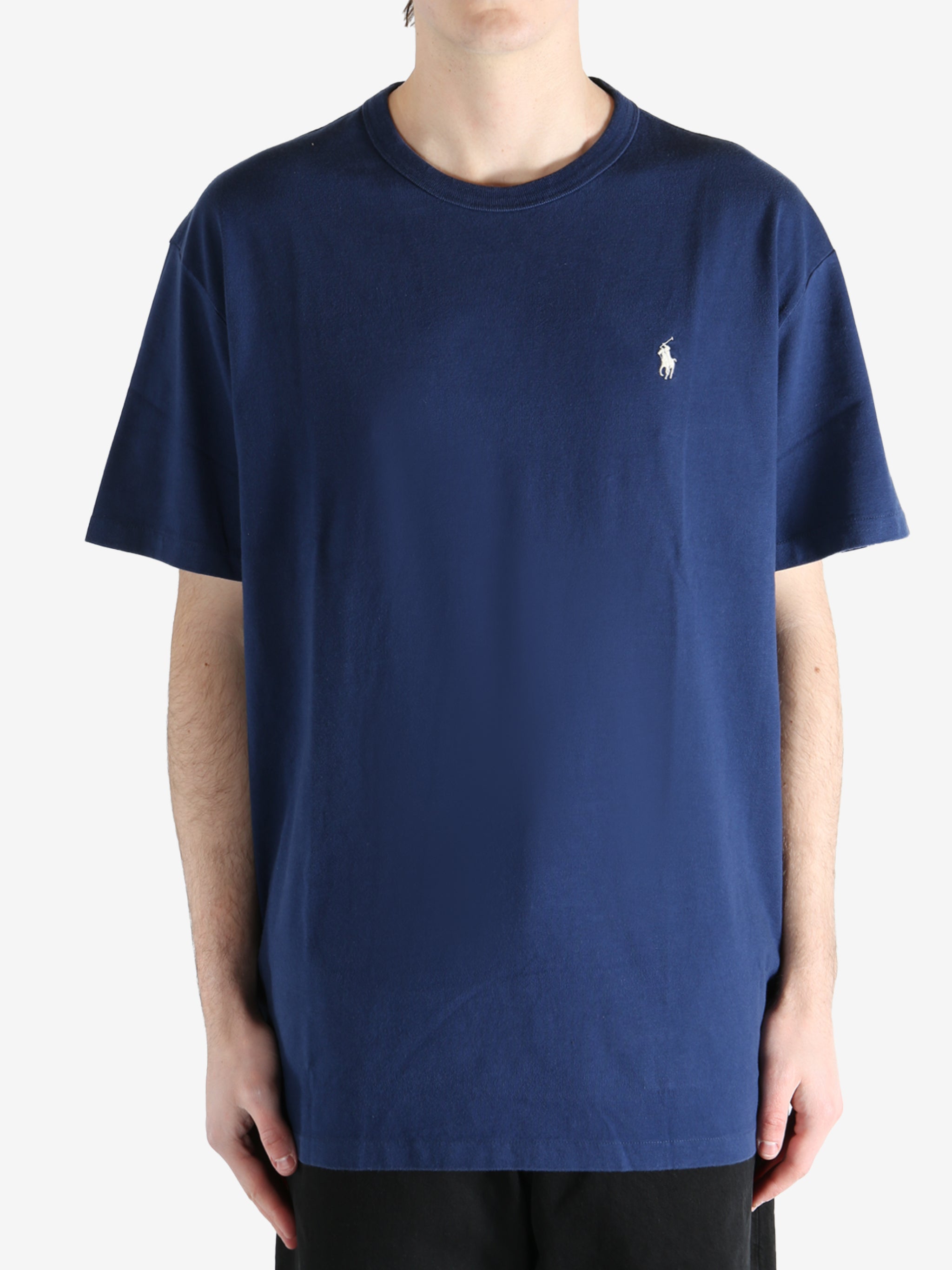 Navy blue t-shirt worn by a person, showing the shirt's fit