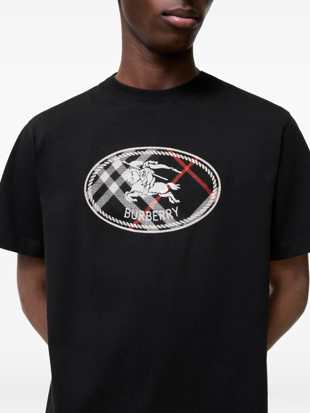 Black t-shirt worn by a person, showing the t-shirt fit