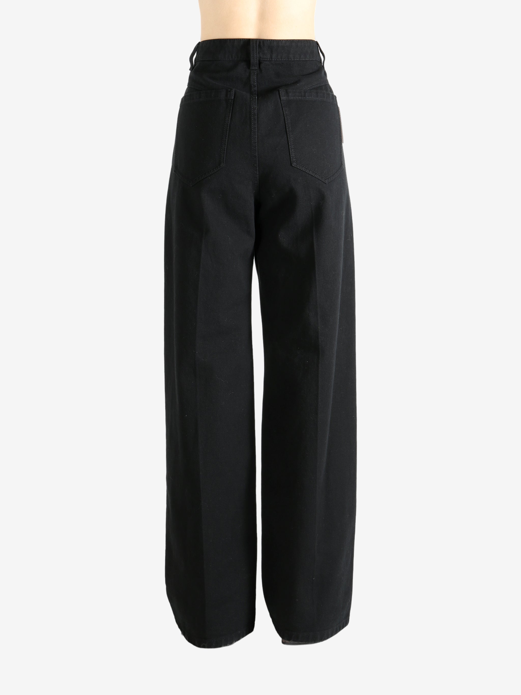 Black pants worn by a person, showing the pant's fit