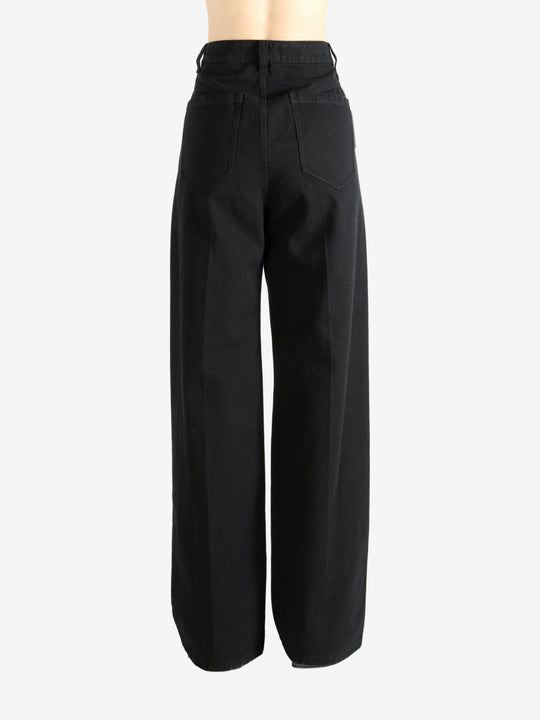 Black pants worn by a person, showing the pant's fit